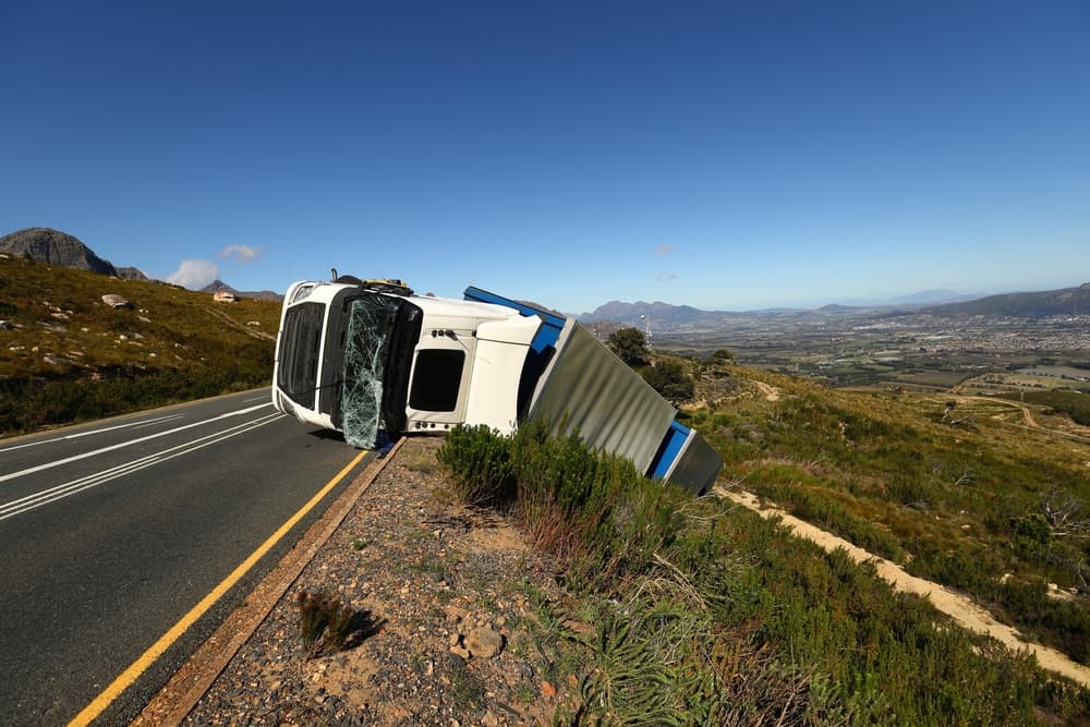 A lorry veered off course and overturned on the road.