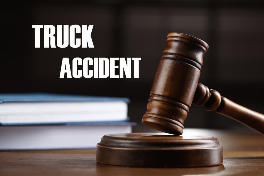 Truck accident law concept: Wooden judge's gavel resting on a table, surrounded by law books, symbolizing legal proceedings in truck accident cases.
