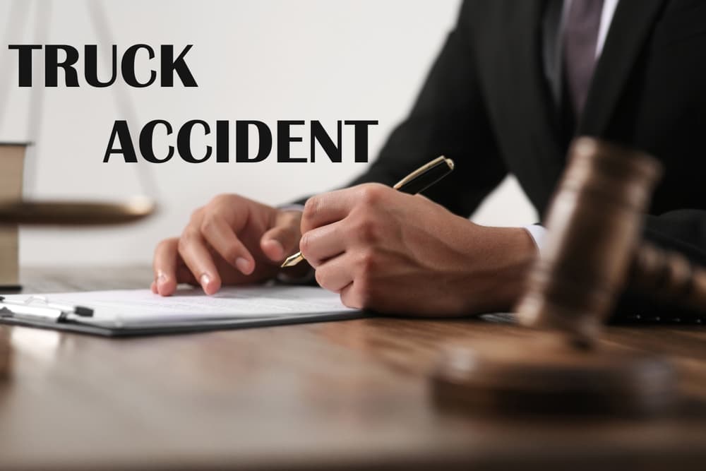 Truck accident law concept. Close-up of a judge working at a wooden table with legal documents and a gavel.