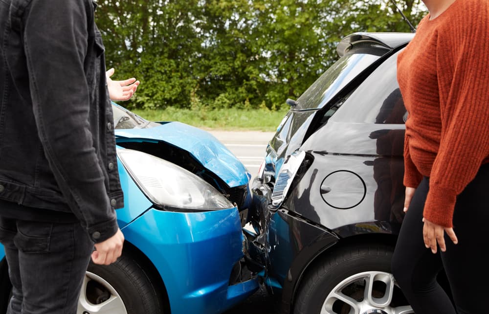 Two angry drivers arguing over who is at fault for a car accident.
