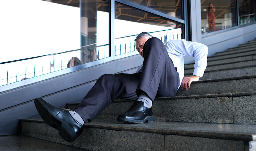 A man falls down the stairs in a public setting in Athens, GA