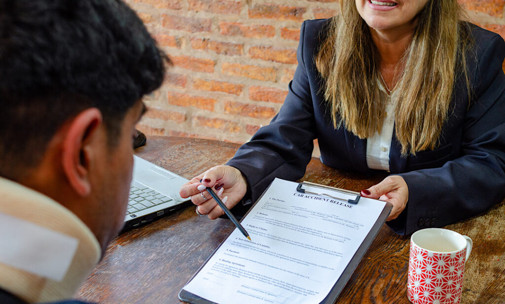 Hall and Collins injury lawyers reviewing car accident evidence and records with Athens client