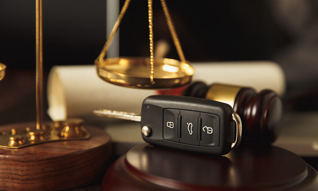 Close up of judge gavel and car keys over soundboard reviewing car accident case in Athens, Georgia